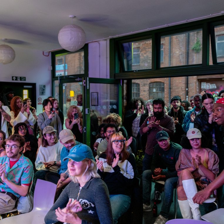 View of applauding audience, seated and stanging