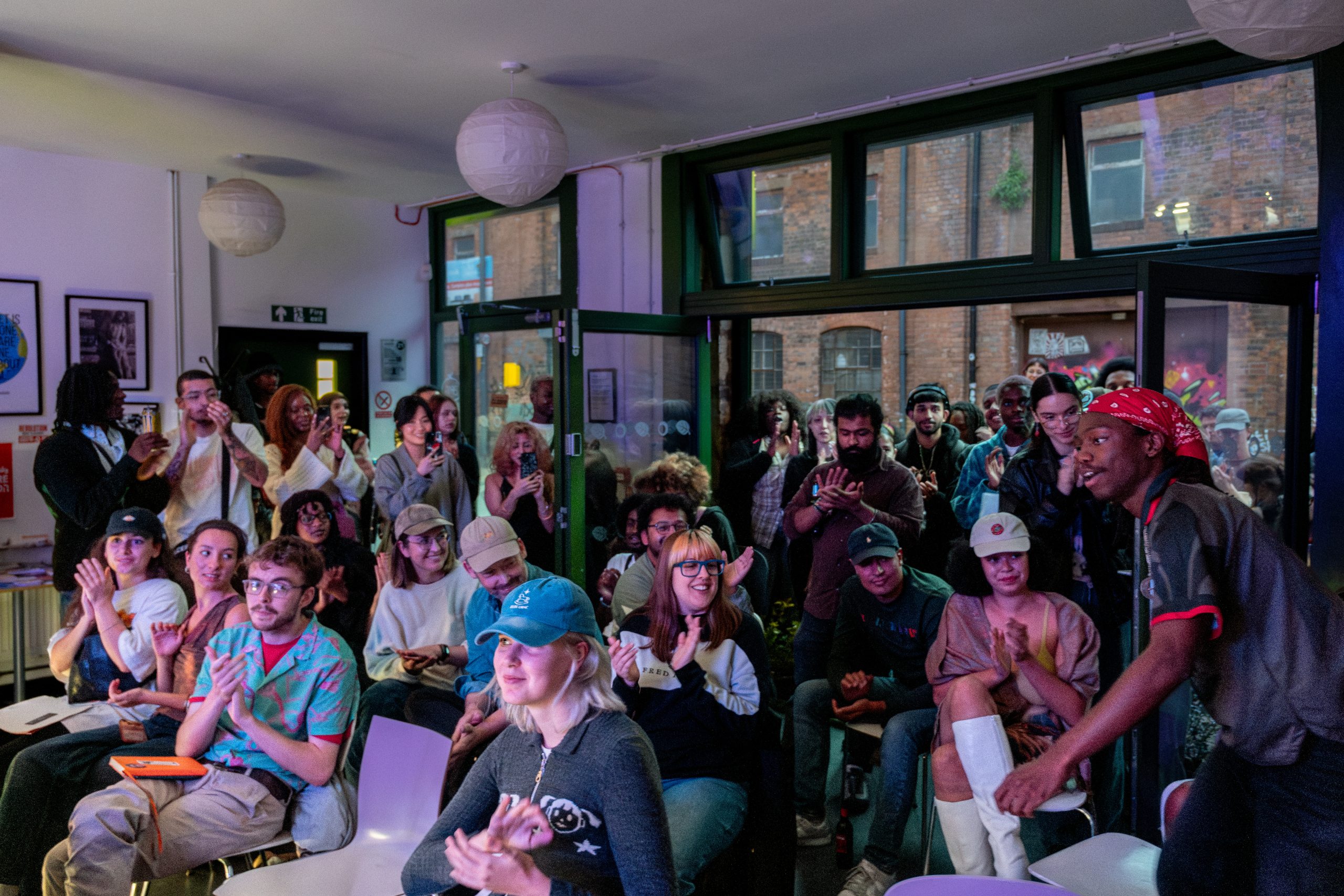 View of applauding audience, seated and stanging