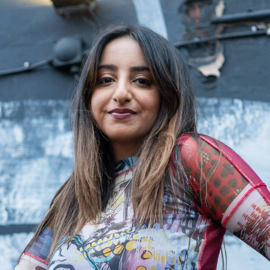 Headshot of Erinn with industrial background