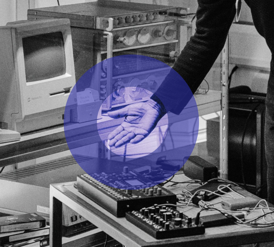 Black and white image of Gary's hand gesturing towards technical equipment